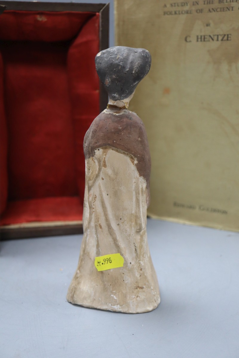 A Tang terracotta figure of a lady (a.f.) and Hentze, C. - A study in the beliefs of folklore of ancient China and a boxed Chinese tomb